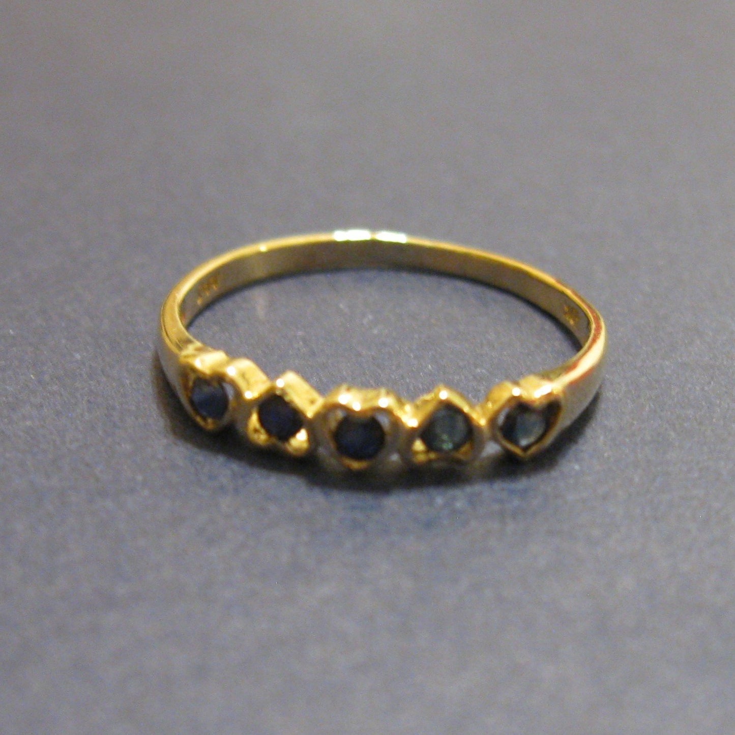 10k yellow Gold Ring with 5 Dark Blue Stones bezel set in Hearts.